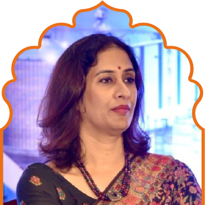 Woman with medium-length dark hair wearing a traditional Indian saree and necklace, looking to the side with a calm expression.