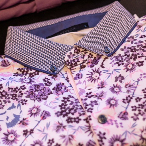 White leather sneakers paired with folded floral print shirts