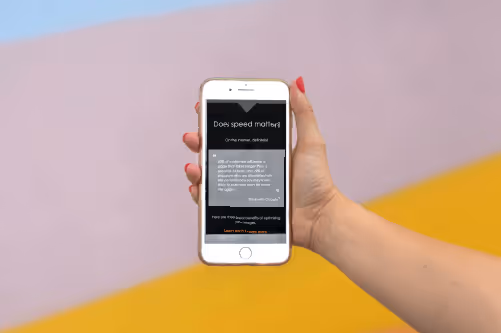 Holding a phone demonstrating a course created in dominKnow | ONE