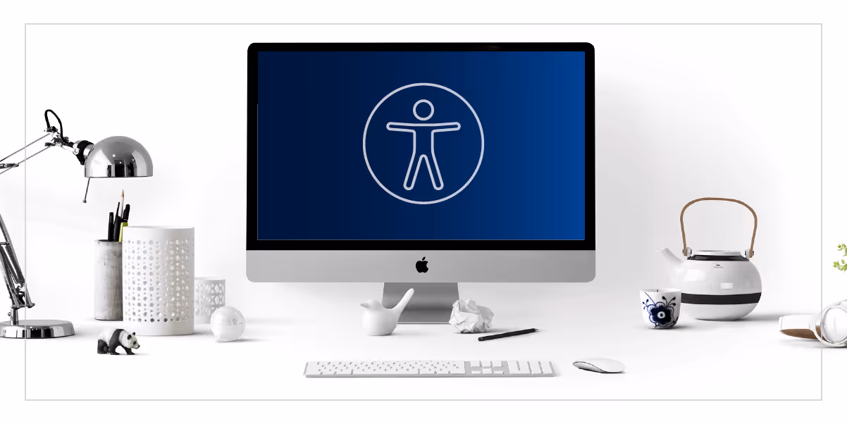 Photograph of a desktop with a computer monitor displaying an accessibility symbol.