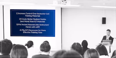 Photo of adults in a training classroom with a slide presentation projected on a screen.