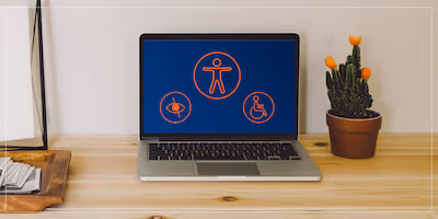 Photo of a laptop computer on a desk displaying accessibility logos