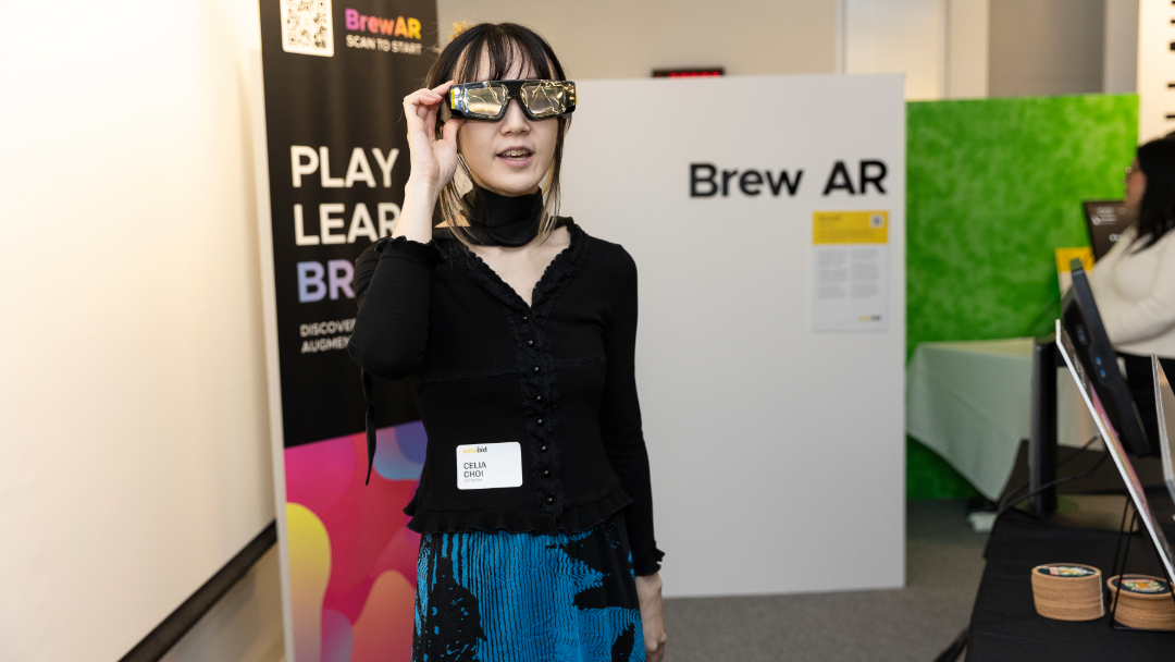 Woman in VR goggles at SMC IxD Grad Show.