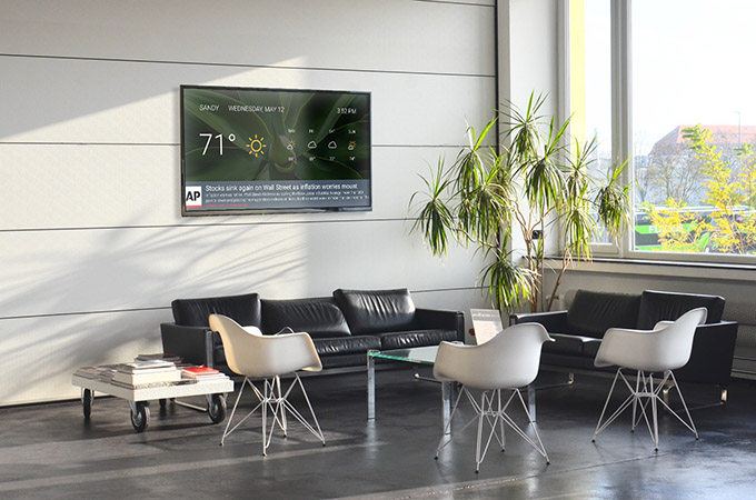 Lobby screen with weather and news in a waiting area