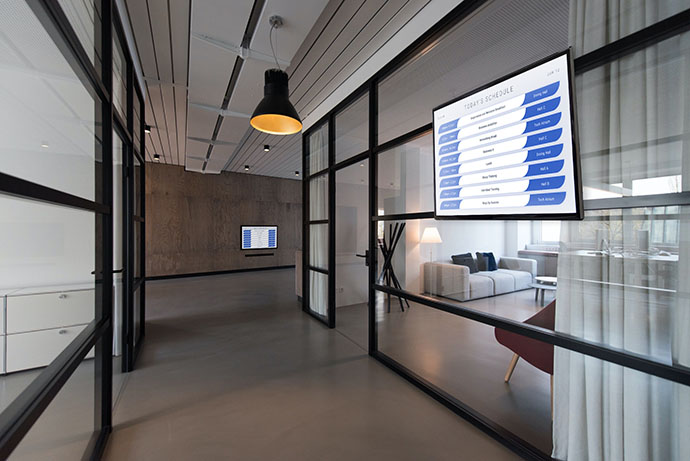 Wall-mounted screen running a room schedule