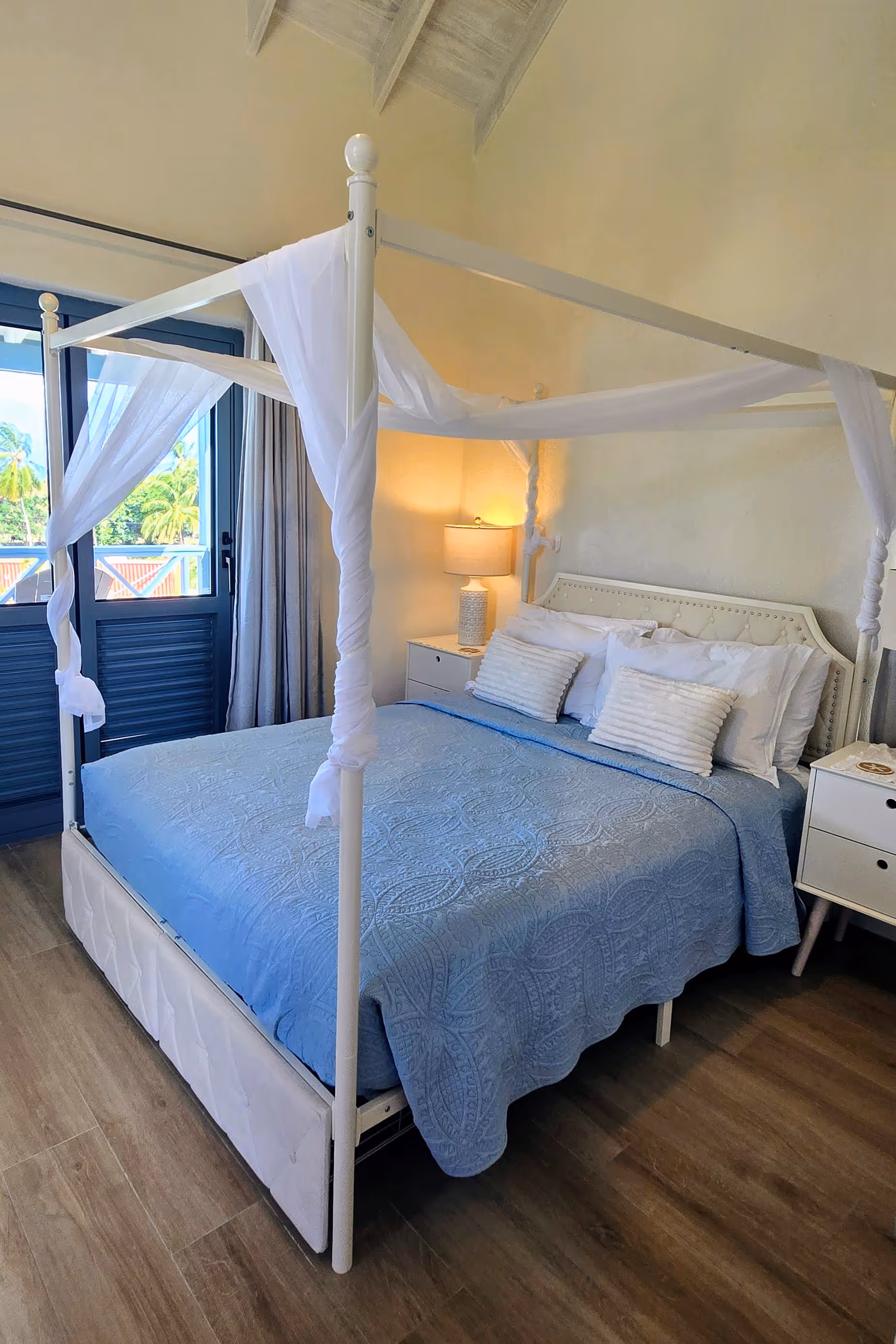 queen size bed in room with window 