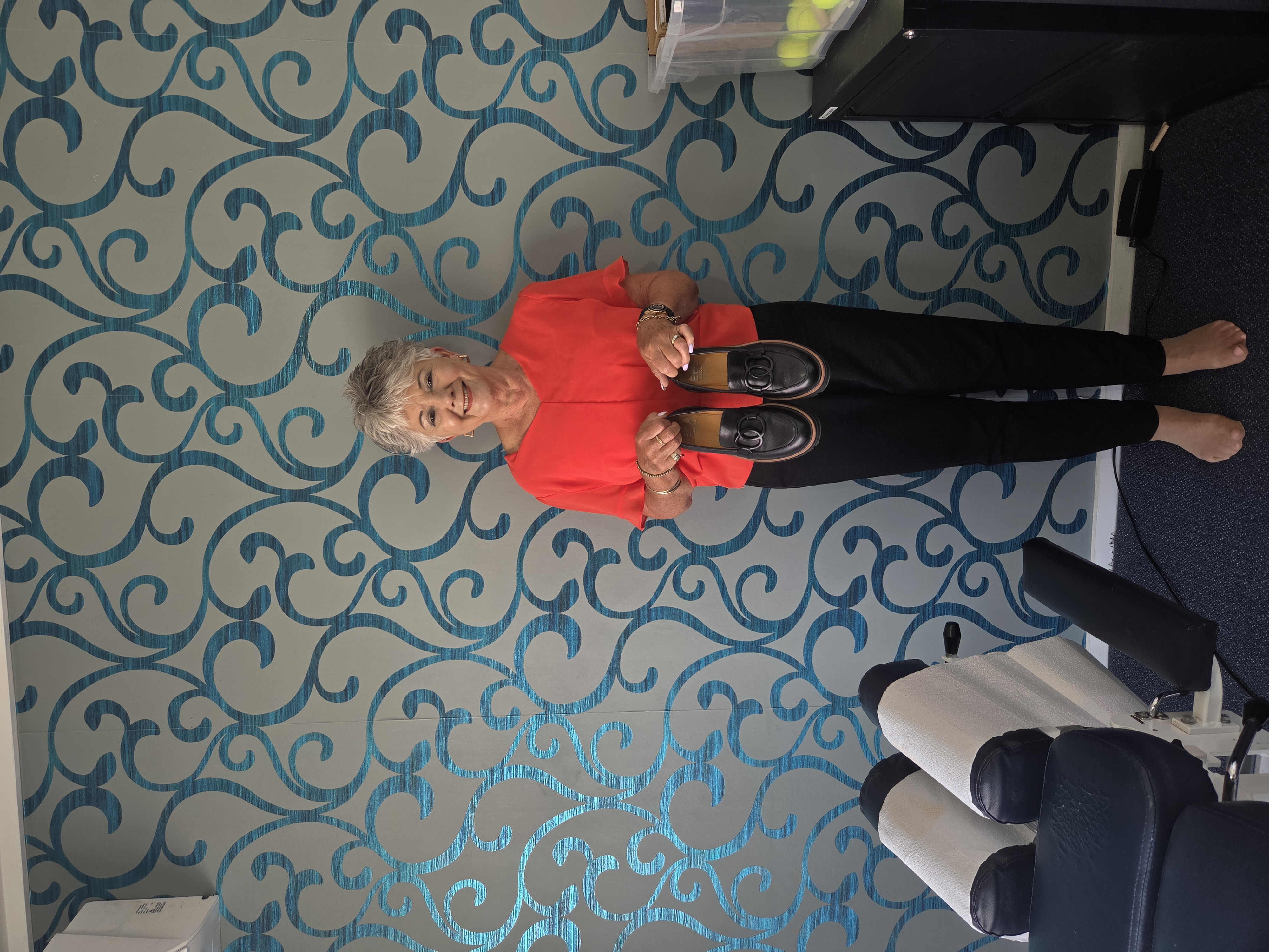 Karen holding her shoes