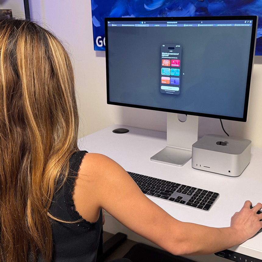 A user testing photo showing an early Lived prototype being tested on a desktop monitor.