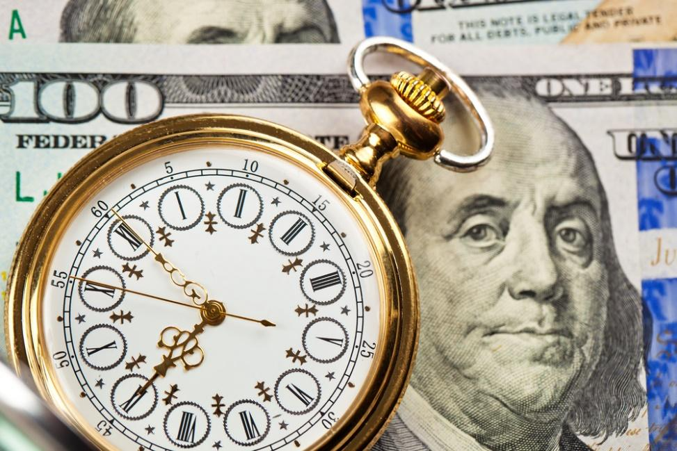 A pocket watch on top of moneyAI-generated content may be incorrect.