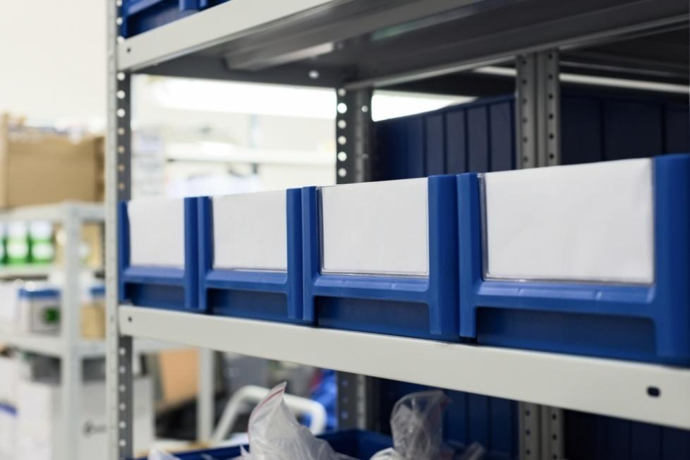 A row of blue and white bins on a shelfAI-generated content may be incorrect.