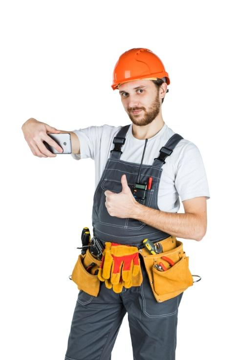 A person in a hard hat taking a selfieAI-generated content may be incorrect.