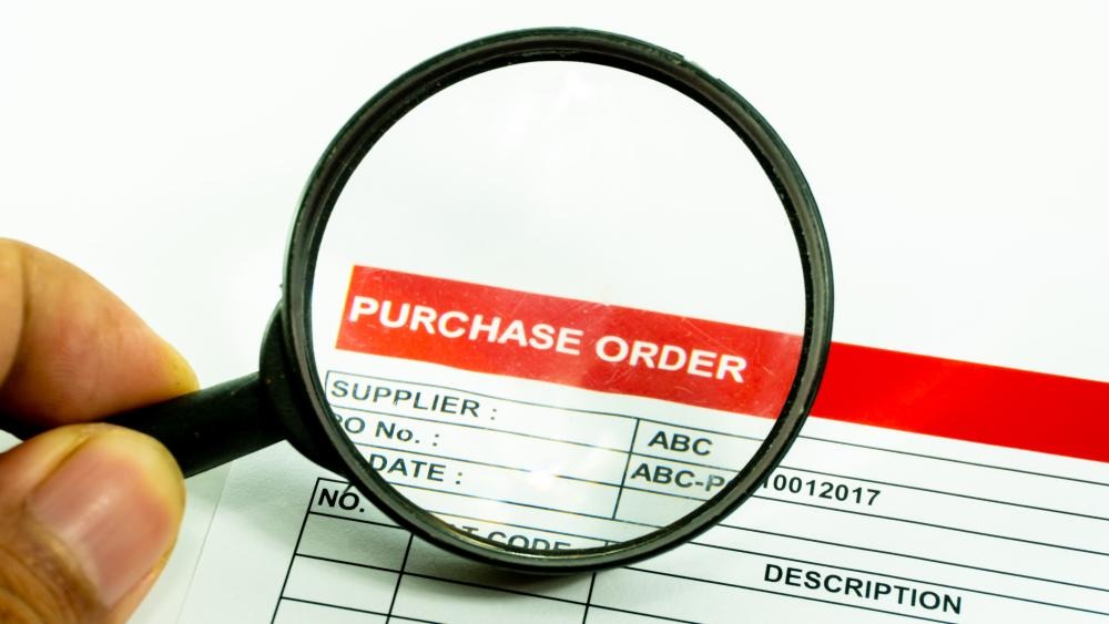 A magnifying glass over a purchase orderAI-generated content may be incorrect.