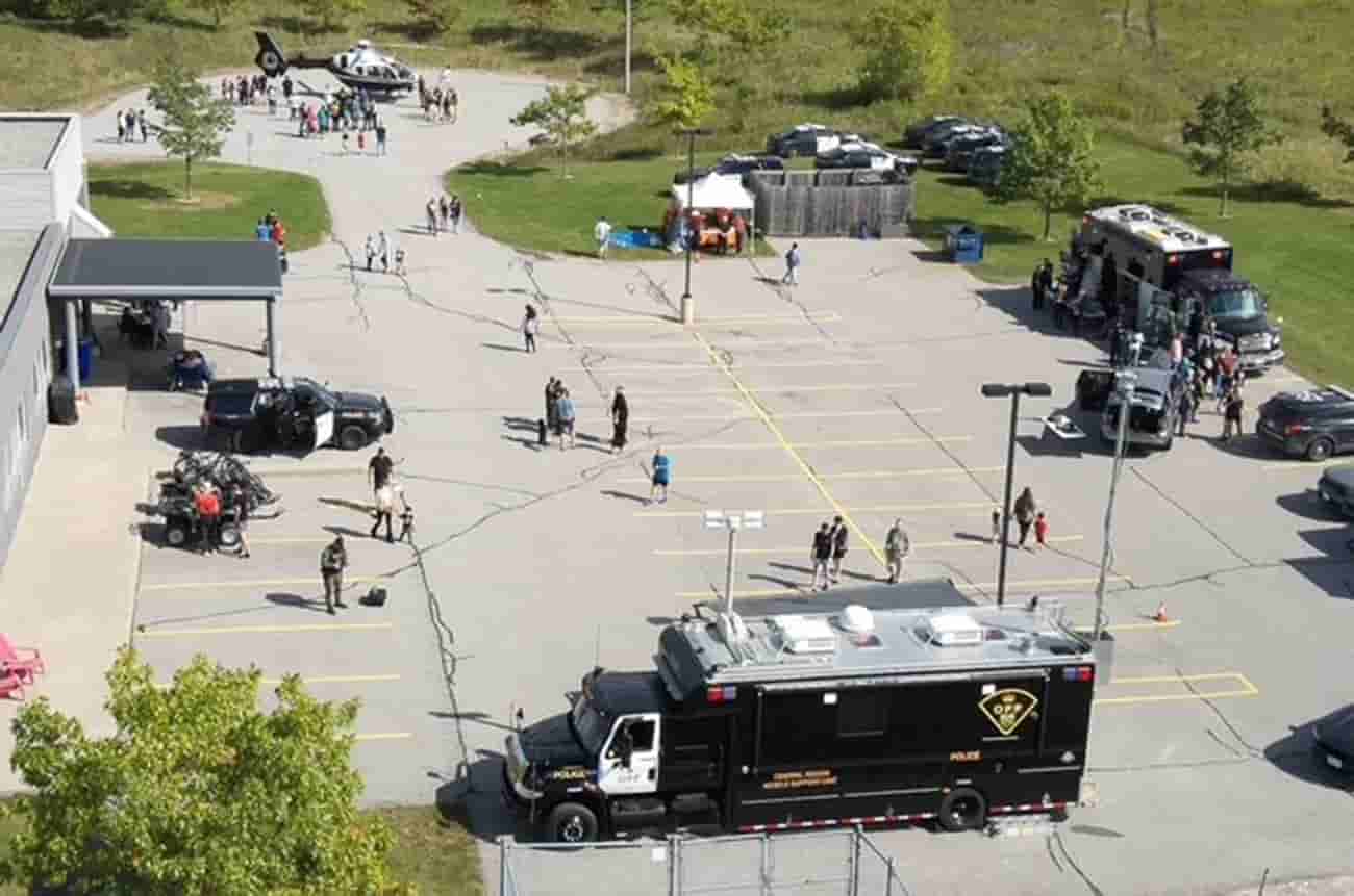 Elevated view of a parking lot showing a number of OPP vehicles, including a cruiser, cargo vehicle, and helicopter