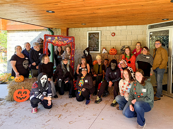 Group photos of staff, volunteers, etc. at the entrance to Mono Community Centre