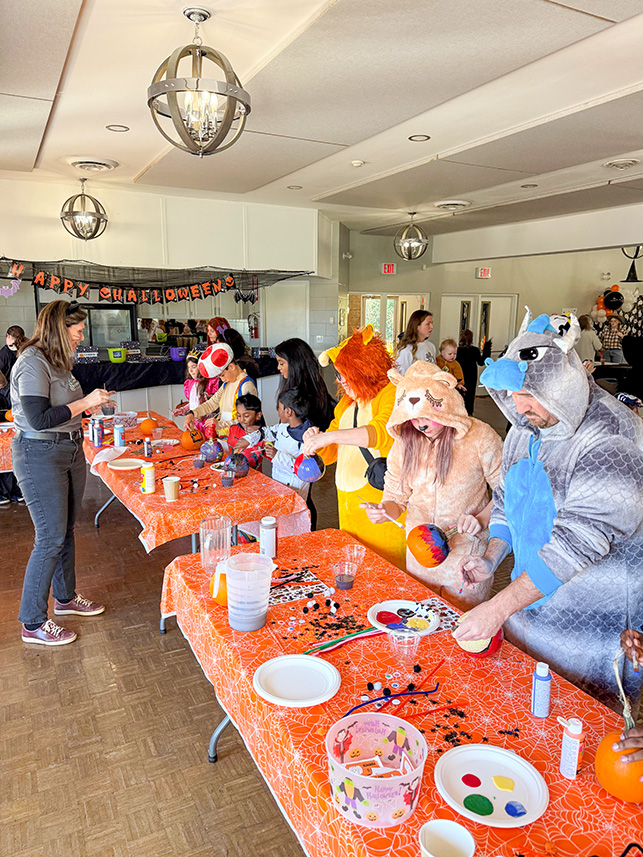 Attendees decorating pumpkins