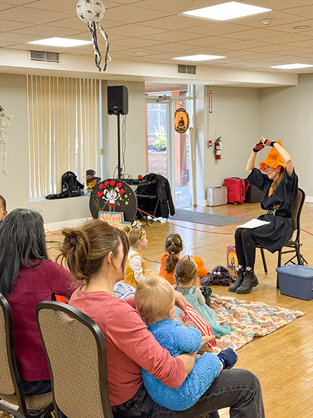 Orangeville Library staff doing story time at the Halloween party