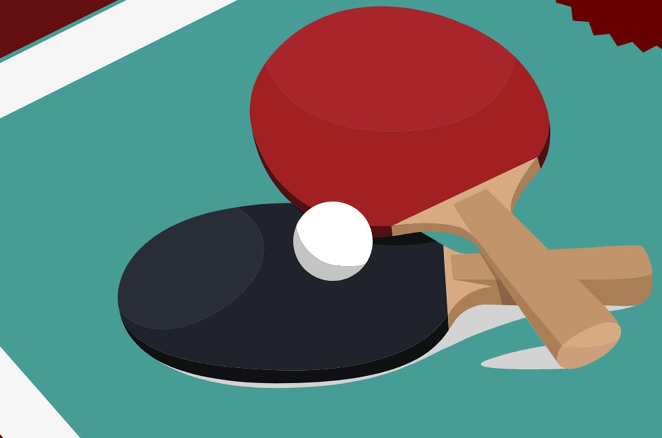 Two ping pong paddles with a ball on a ping pong table