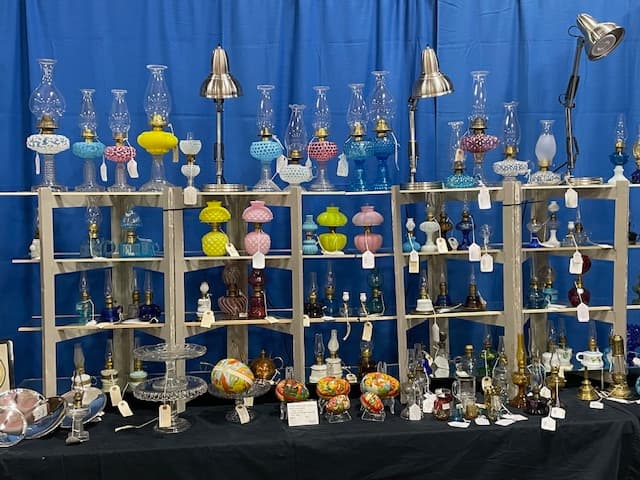 Shelves with a variety of antique lamps