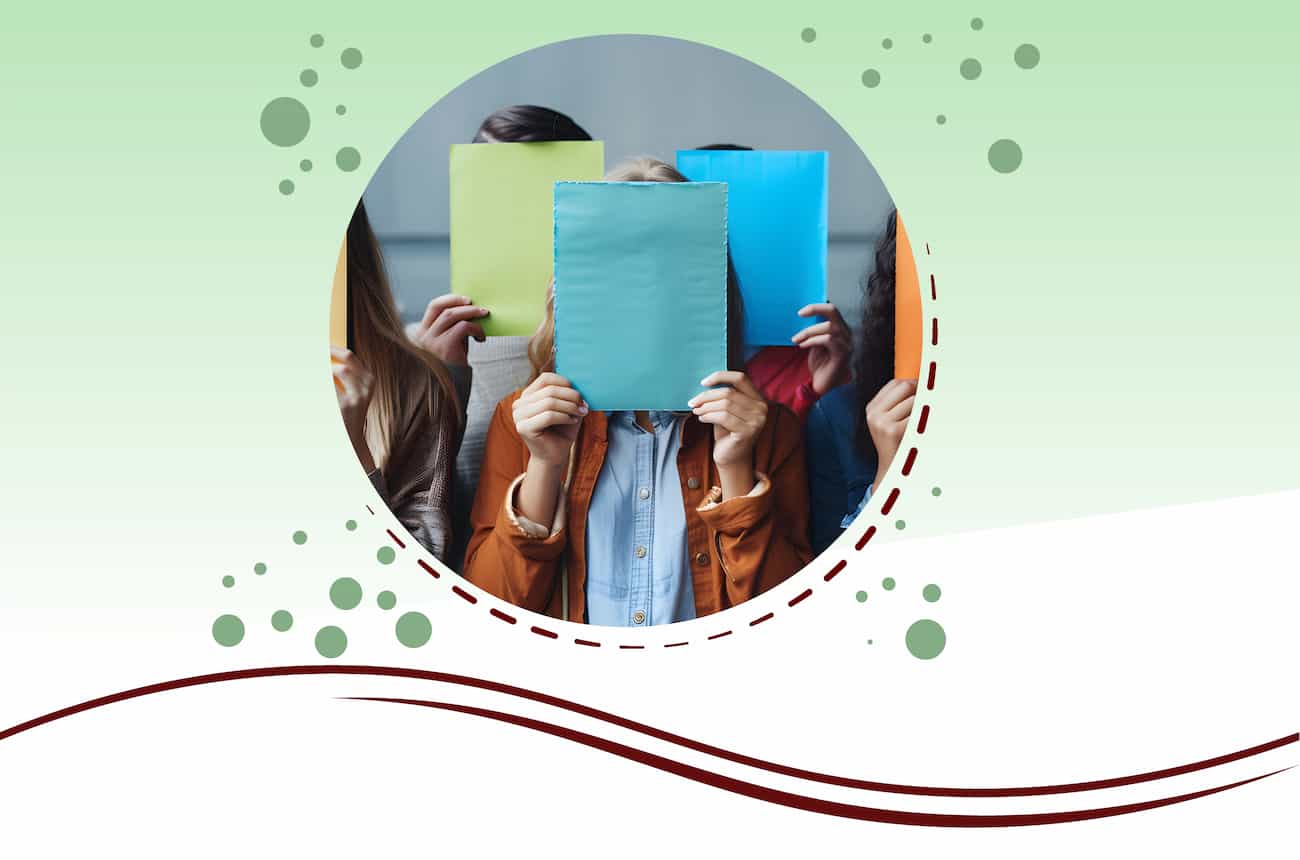 Group of people holding papers in front of their faces