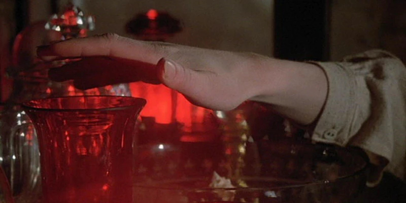 Hand hovering over glass with red light