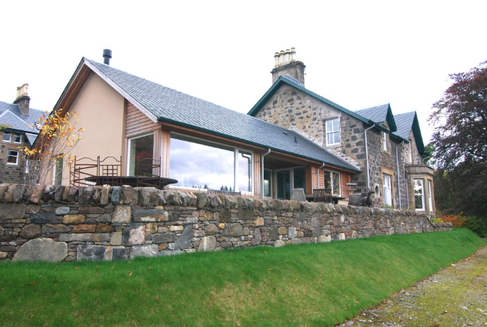 A new extension which takes advantage of the beautiful light and southerly view over the loch, and provides easy access to a partially roofed terrace.