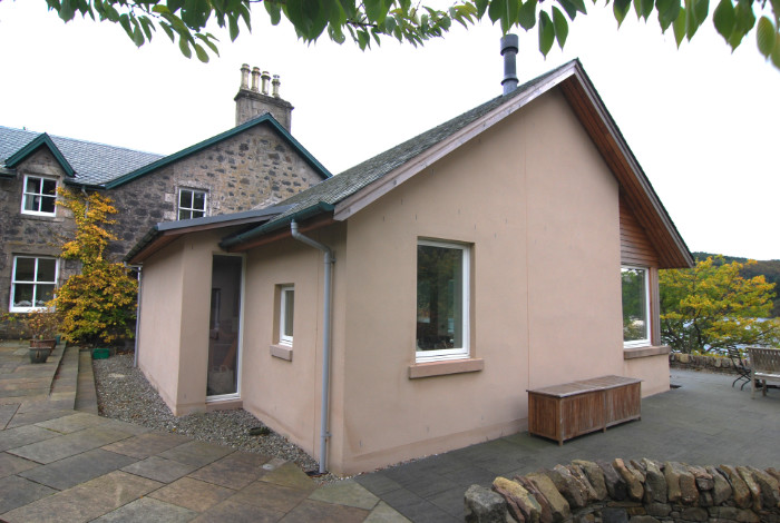 A new extension which takes advantage of the beautiful light and southerly view over the loch, and provides easy access to a partially roofed terrace.