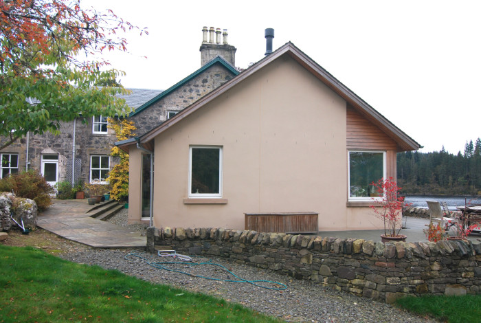 A new extension which takes advantage of the beautiful light and southerly view over the loch, and provides easy access to a partially roofed terrace.