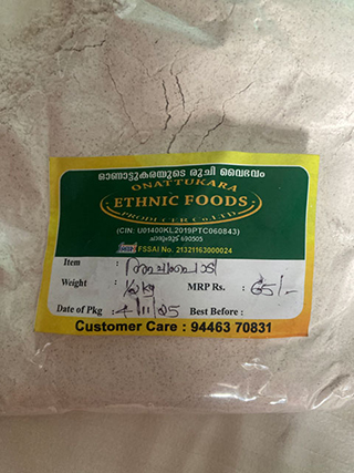 Packaging label for Onattukara Ethnic Foods with handwritten details about item, weight, price, and date of packaging on a plastic bag containing a beige powder.