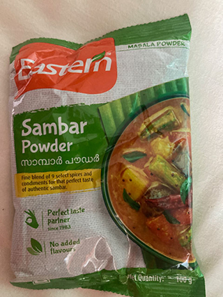 Packet of Eastern brand Sambar Powder with image of sambar curry and text highlighting fine blend of spices, no added flavours, and perfect taste.