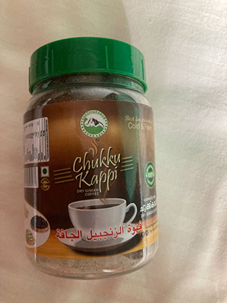 Jar of Chukku Kappi dry ginger coffee with green lid and a white coffee cup illustration on the label.
