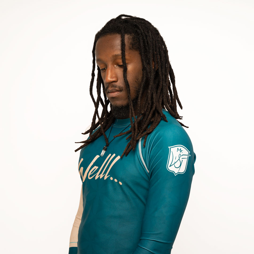 Wildenfree Teal Rashguard, Left side with Wildenfree shield in white, on the shoulder