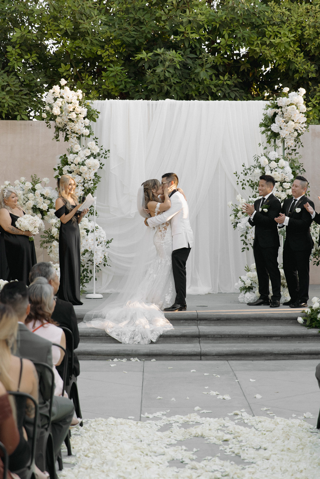 Bride and groom share ceremony kiss as husband and wife.