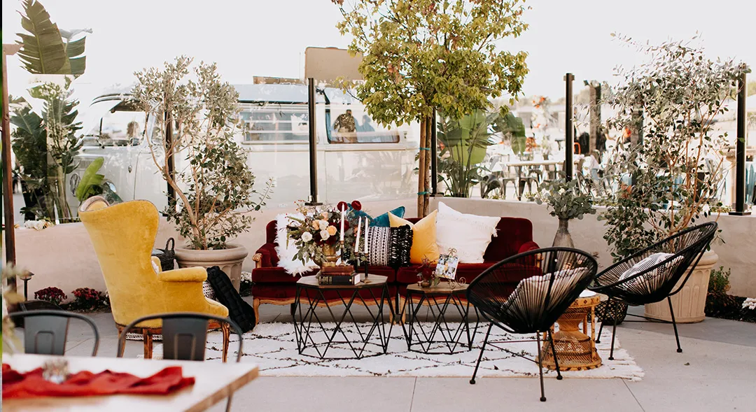Outdoor lounge seating surrounded by greenery on the Hangar 21 terrace