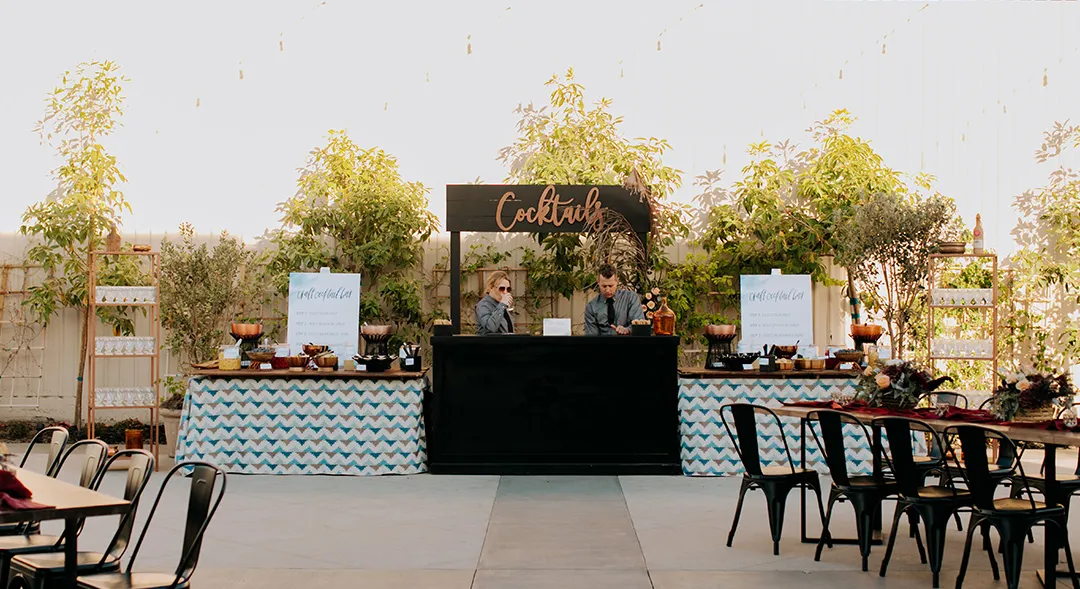 Outdoor cocktail bar and reception tables on the Hangar 21 terrace