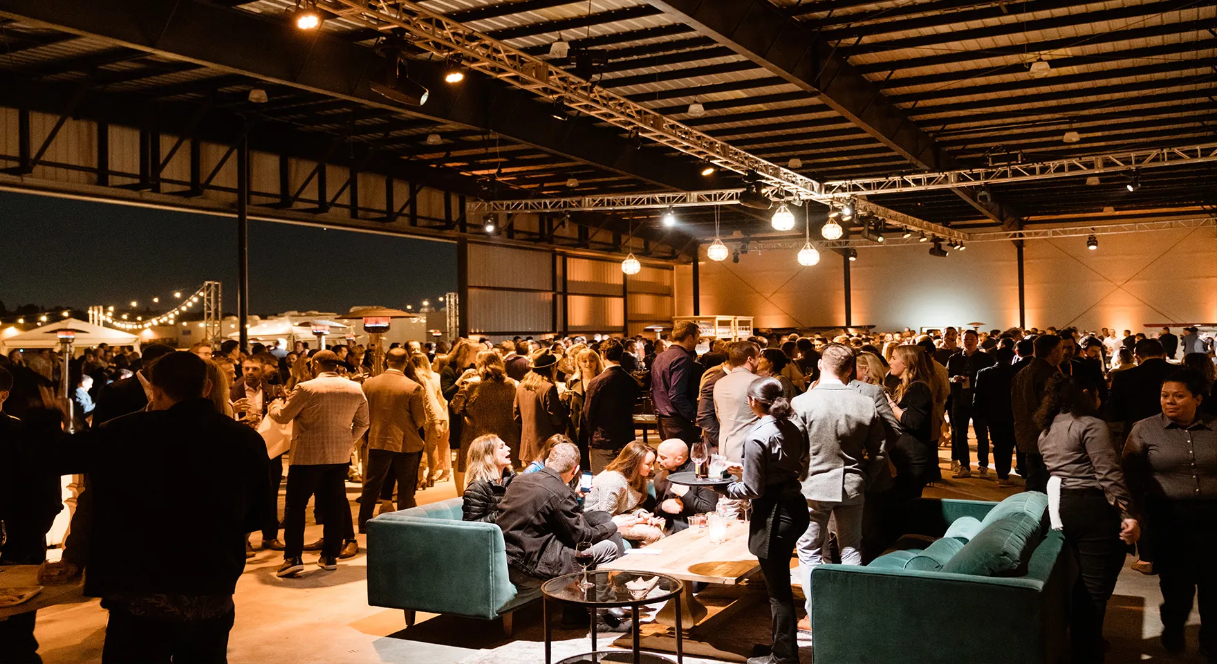 Guests gathering around lounge seating during an Executive Hangar reception