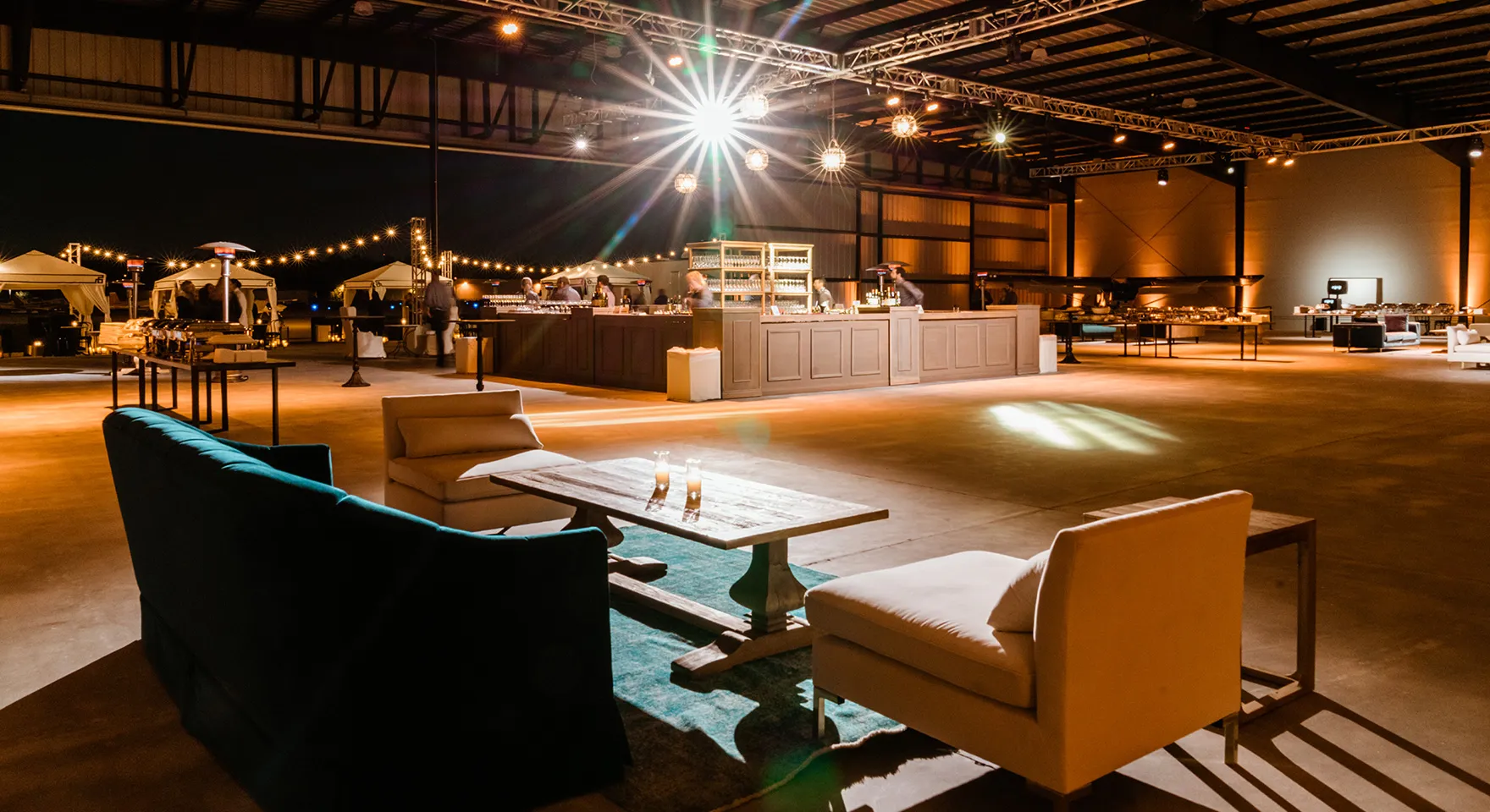 Lounge seating and a central bar inside the Executive Hangar