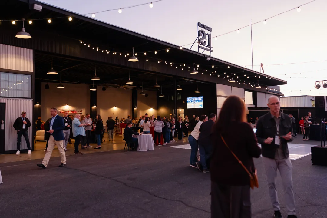Guests gathering inside and outside Hangar 21 during a convention kickoff party