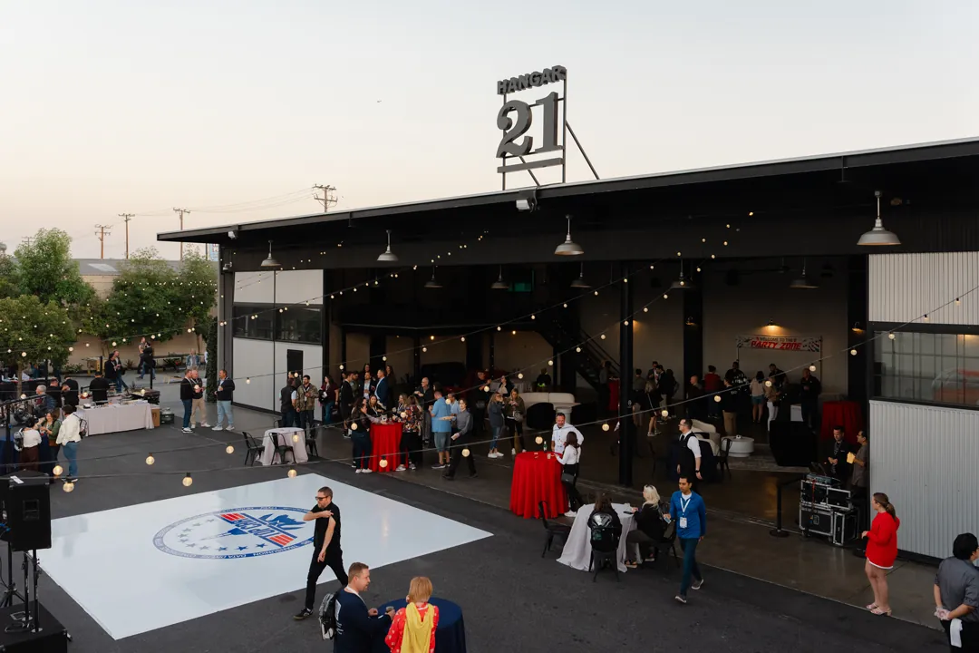 Convention kickoff reception inside the open hangar at Hangar 21