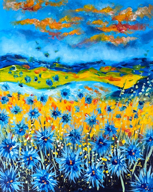 Painting of a vibrant, high-contrast wildflower field glowing with bold blue and warm orange tones against a soft, dreamy sky.