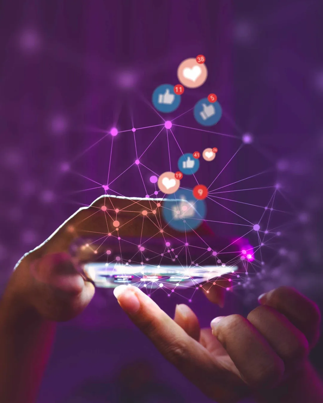 Hand holding smartphone with floating social media reaction icons and connecting network nodes on purple background.