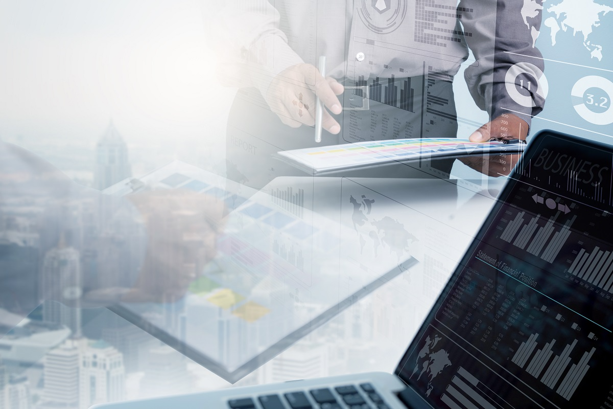 Business professional reviewing digital documents and analytics dashboards used in AI-powered data room platforms