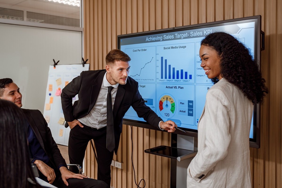 Investors and executives reviewing financial performance dashboards during fundraising due diligence