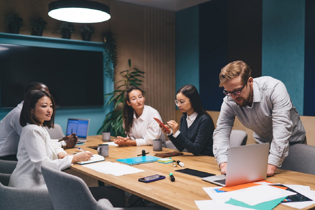 Business team using a virtual data room to review confidential documents during a due diligence meeting