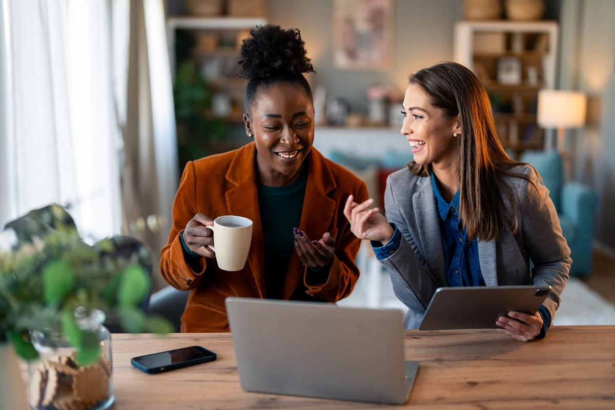 Two professionals reviewing documents together in a virtual data room during remote due diligence collaboration