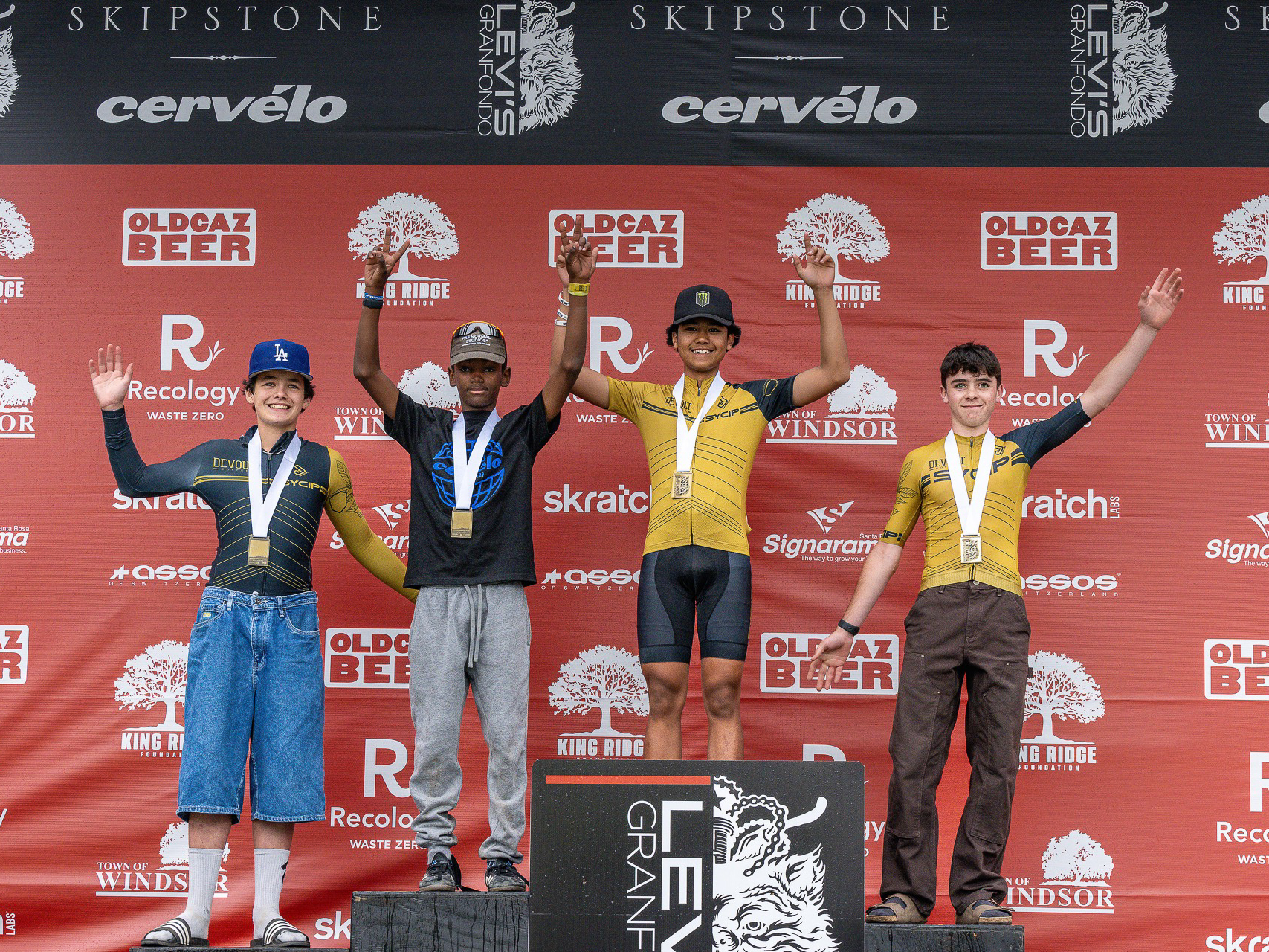 Junior race podium — four young racers celebrating
