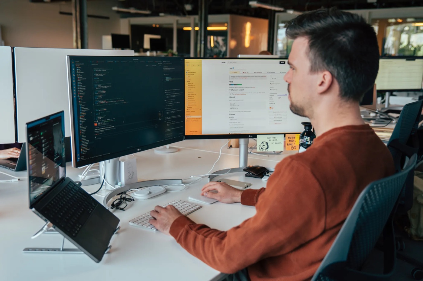 A Nimble developer coding at a dual-screen setup