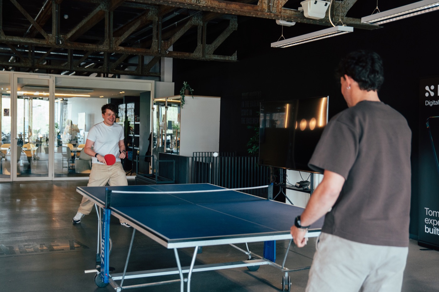 Nimble colleagues playing table tennis