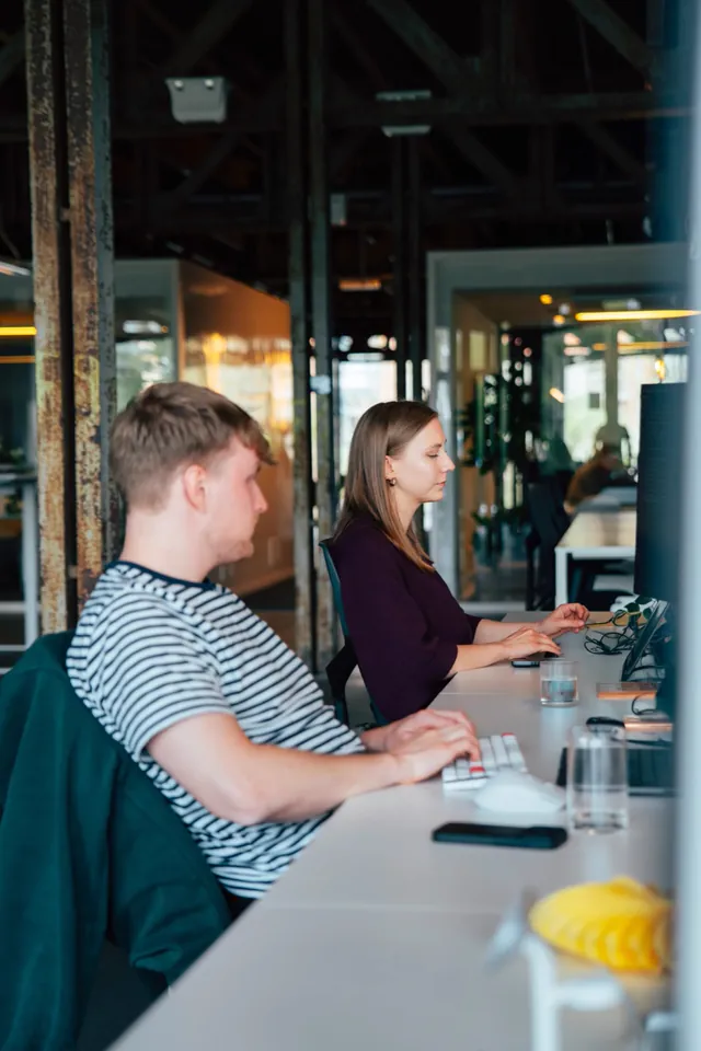 Nimble team members working together at their desks