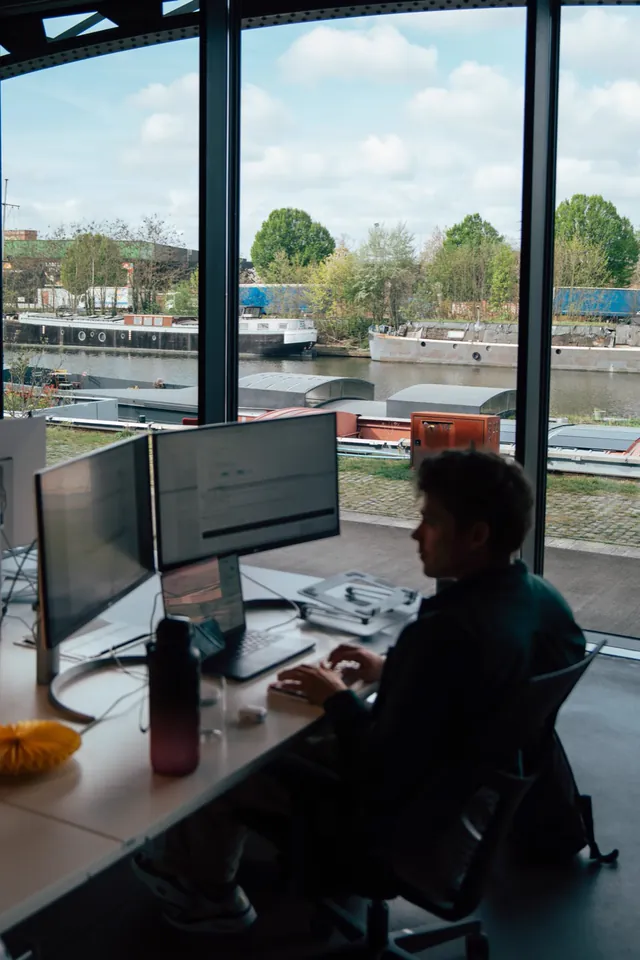 A Nimble developer working by the window