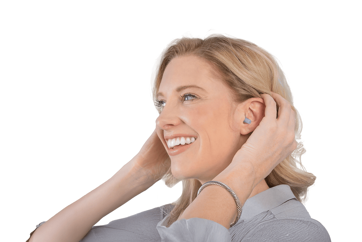 Picture of a woman smiling with EarPlanes earplugs in her ear